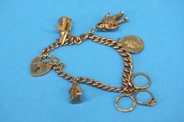 A 9ct gold bracelet with padlock fastener and a collection of charms, weight 29.9gm
