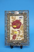An Oriental silver photograph frame, decorated with birds and foliage. Stamped SF90