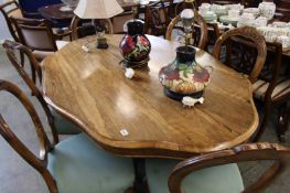 A Victorian Rosewood centre table and six Victorian balloon back chairs