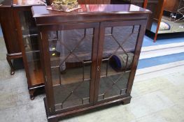 A reproduction mahogany Siesta bookcase 97cm wide