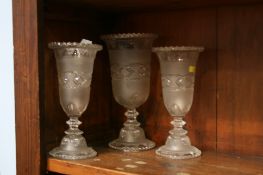 A garniture of three glass vases