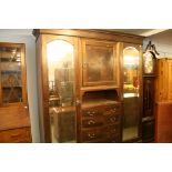 An Edwardian mahogany triple door wardrobe