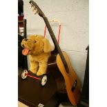 Push-a-long stuffed dog and a guitar