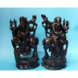 A pair of carved wood Oriental figures of an old m