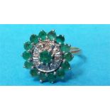 An 18ct gold emerald and diamond cluster ring