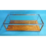 A Merrow Associates rectangular clear glass coffee table with chrome supports and rosewood