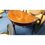 A mahogany half moon fold over card table. 89 cm wide