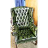 Green leather wingback armchair