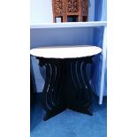 A pair of stonework top tables with black bases. 73 cm diameter