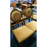 A pair of gilt and upholstered chairs