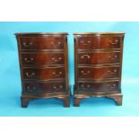 A pair of reproduction mahogany serpentine chest of drawers