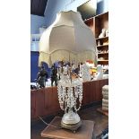 A tall decorative glass table lamp