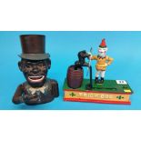 A money box 'Trick dog' and a cast iron African Am