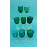 Eight small wine glasses with green bowls and clea