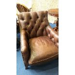 A good quality brown leather button back armchair and matching foot stool