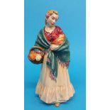 A Doulton and Co. figure of a Romany lady holding