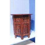 A small Indian carved octagonal table