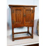 An oak linen fold cabinet