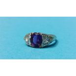 A 9ct gold ring set with oval amethyst flanked by