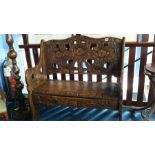 A floral carved two seater bench