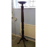 A mahogany torchere