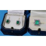 A white metal emerald ring with a pair of matching earrings, stamped 18ct