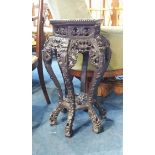 A Chinese carved hardwood octagonal table with inset marble top, 28cm wide