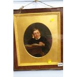 Oval portrait of a school boy within a rosewood fr