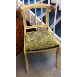 A cream painted chair with gilt rams head finials