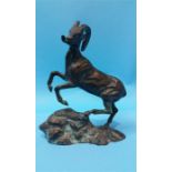 A bronze model of a rearing mountain goat supporte