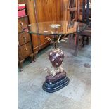 A modern glass topped occasional table on brass an