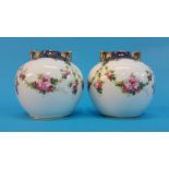 A small pair of Royal Doulton two handled globular shaped vases, decorated with garlands of flowers;
