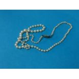 A long string of pearls with diamond clasp