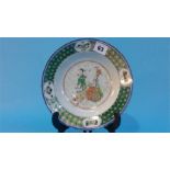 An 18th century Chinese famille verte circular plate, the centre decorated with figures, 21.5cm