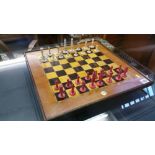 A stained ivory chess set and board