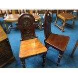 A pair of Victorian mahogany hall chairs