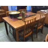 A Teak drawer leaf table and four chairs