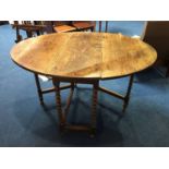 An early 18th century oak drop leaf dining table