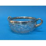 A cut glass bowl with white metal mount