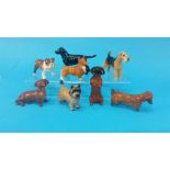 A collection of 8 Beswick dogs etc.