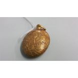 A gold oval locket, stamped 15ct. 17.1gm