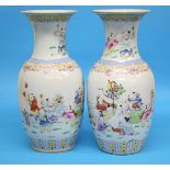 A pair of Chinese famille rose vases decorated with figures. 42.5cm high