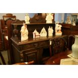 A heavily carved oak sideboard