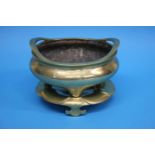 A Chinese polished bronze censer and stand, with seal mark to base. 24 cm diameter by 16.5 cm high