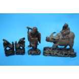 A carved group of a man riding a water buffalo, a small carved rootman etc.