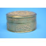 A Chinese repousse box and cover, decorated with foliage and phoenix in flight. 10 cm diameter