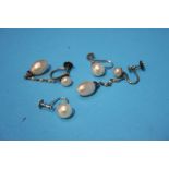A pair of white gold pearl earrings and another pair of silver pearl earrings