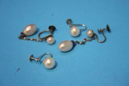A pair of white gold pearl earrings and another pair of silver pearl earrings