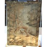 A large Chinese silk embroidered wall hanging, decorated with prowling tigers in a landscape,
