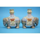 A pair of late 19th Century or early 20th Century famille rose elephant figures, each surmounted